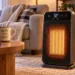 Portable electric space heater with digital thermostat in a cozy living room